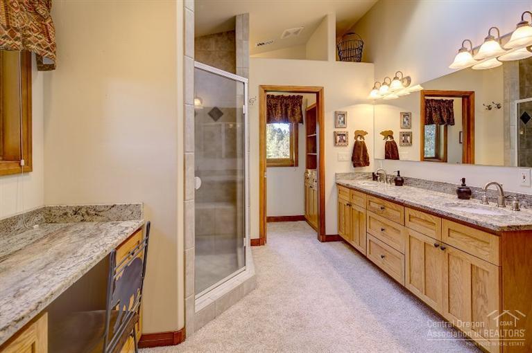 18424 Couch Market Road Bend, OR 97703 - Photo 16 of 25 a spacious bathroom with a granite countertop sink mirror and double