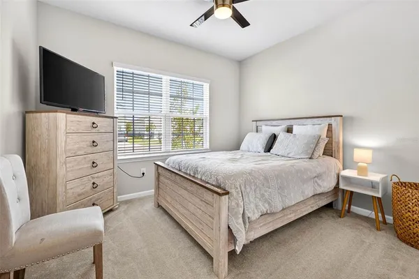 a bedroom with a bed and flat screen tv