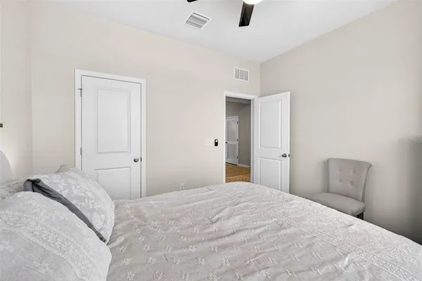 a bedroom with a large bed and closet