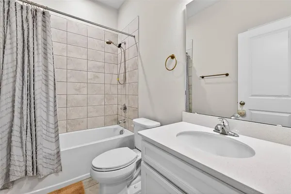 a bathroom with a granite countertop sink toilet a mirror and shower