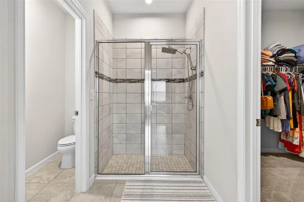a bathroom with a shower and a toilet