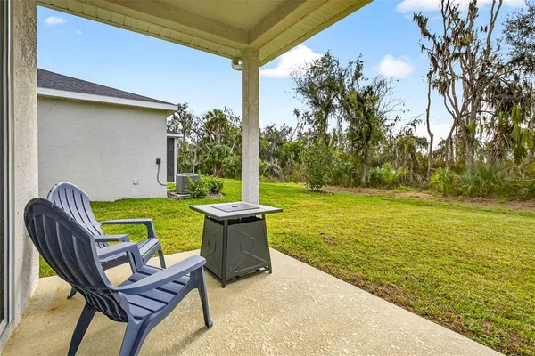a backyard of a house with table and chairs
