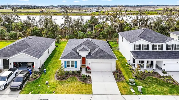 a aerial view of a house with swimming pool next to a yard