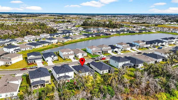 an aerial view of residential houses with outdoor space and swimming pool