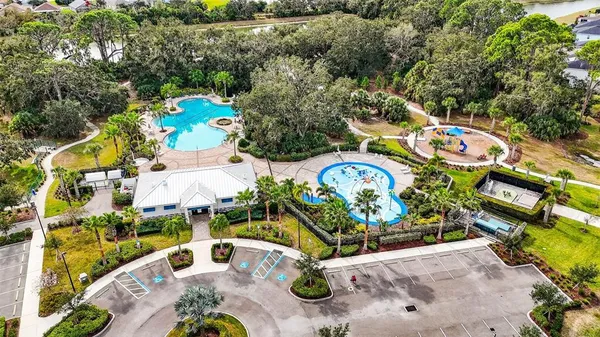 an aerial view of a house with garden space and parking