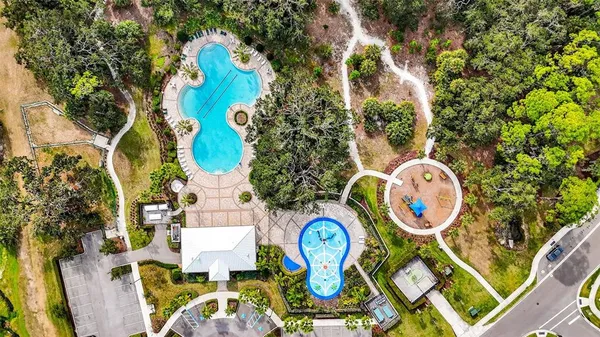 a swimming pool with an outdoor space and seating area