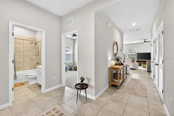 a living room with furniture a flat screen tv and a large window