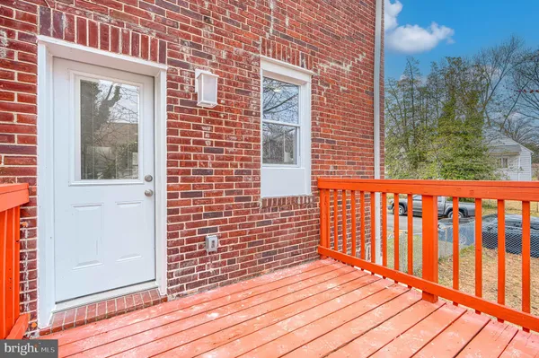 a view of a brick house with wooden floor and a window
