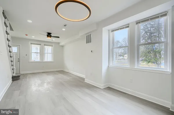 an empty room with windows and closet