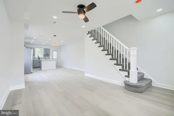 a view of staircase and kitchen with sink