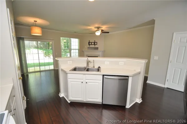 a kitchen with a sink cabinets stainless steel appliances and a window