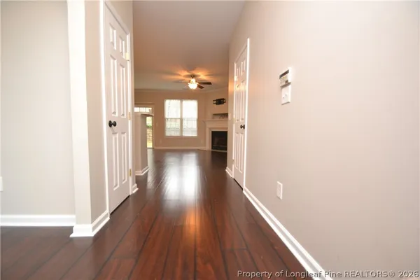 a view of a hallway with wooden floor