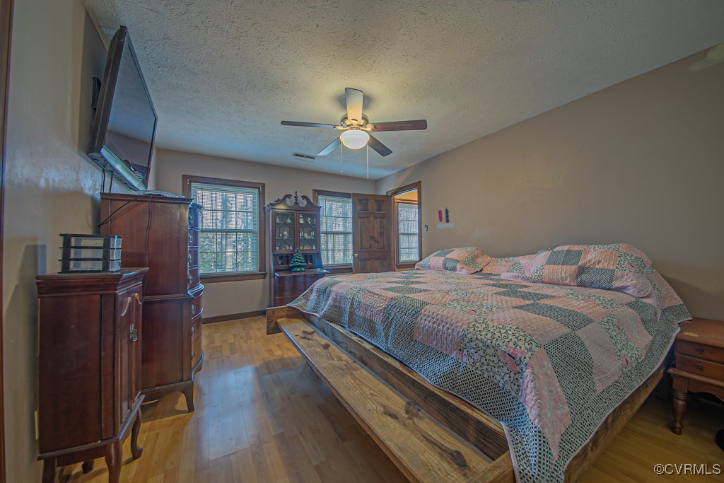 7570 Elko Road Henrico, VA 23231 - Photo 12 of 20 Bedroom with ceiling fan, light hardwood / wood-st