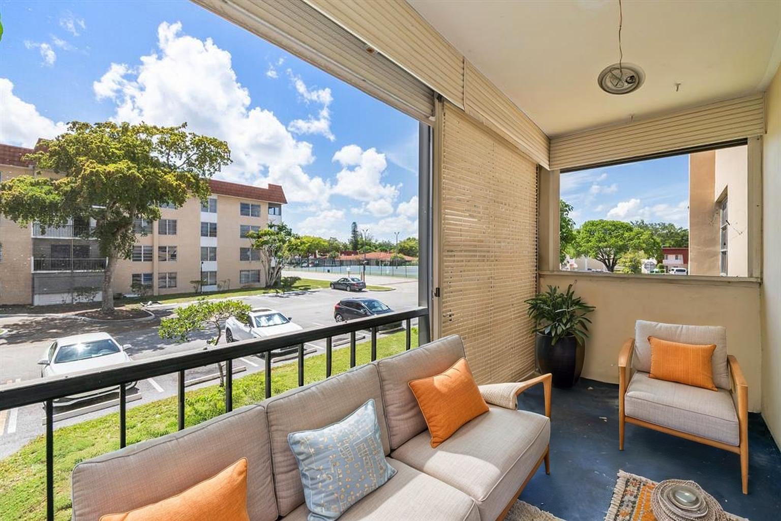 4156 Inverrary Drive, Unit 210 Lauderhill, FL 33319 - Photo 25 of 27 a balcony with furniture and a potted plant