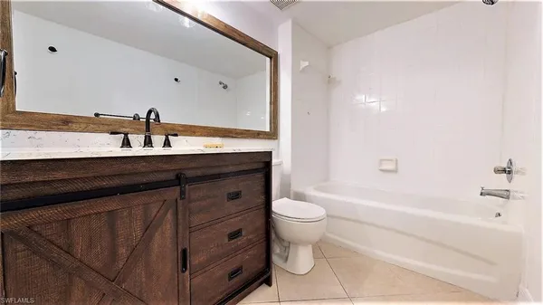 a bathroom with a sink a toilet and bathtub