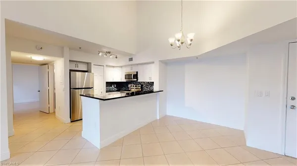 a kitchen with stainless steel appliances a refrigerator sink and cabinets