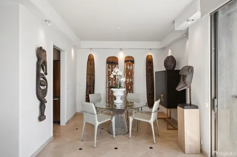 a view of a dining room with furniture and closet