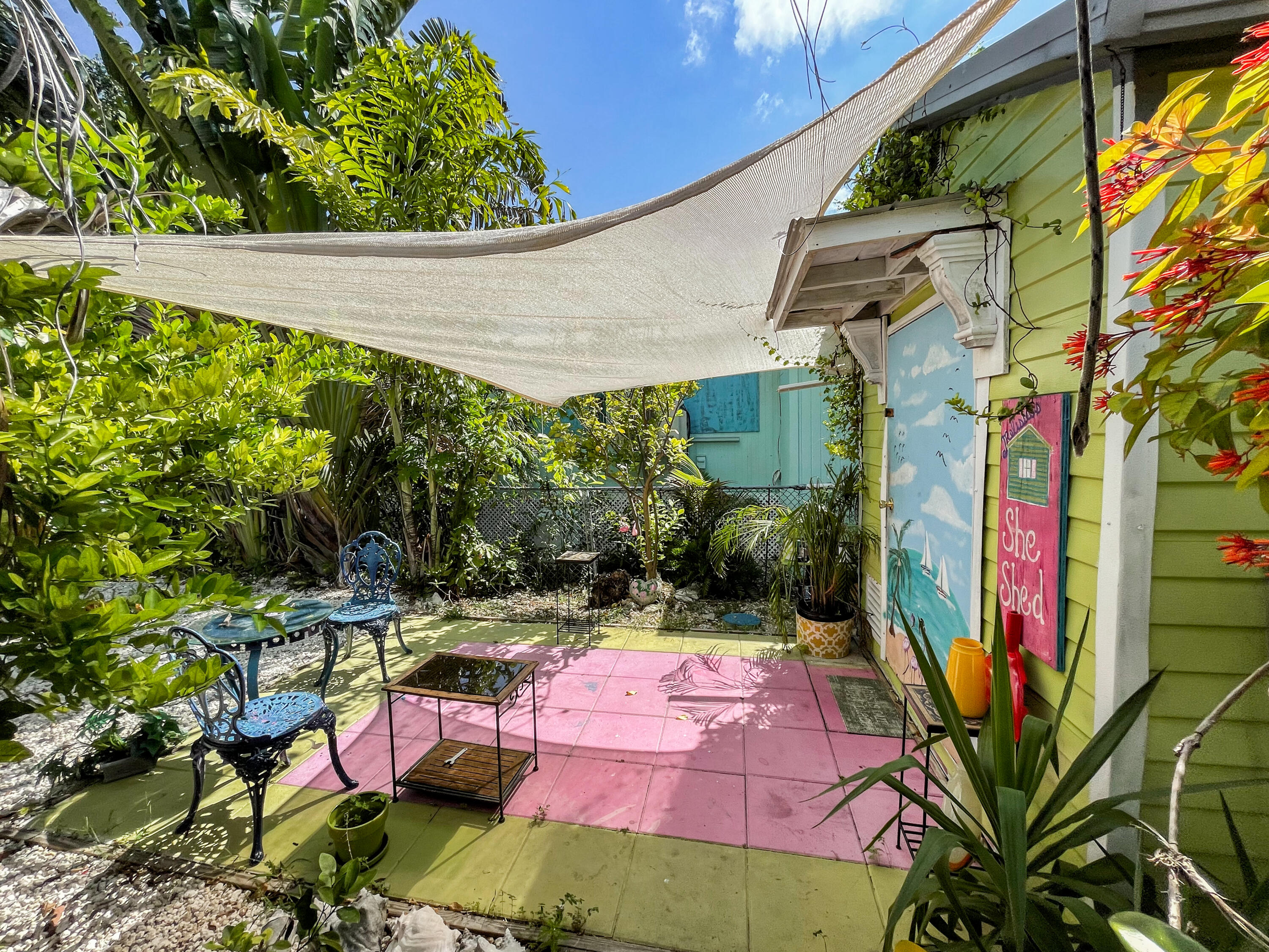 31316 Ave C Big Pine Key, FL 33043 - Photo 18 of 28 an outdoor space with lots of plants and palm tree