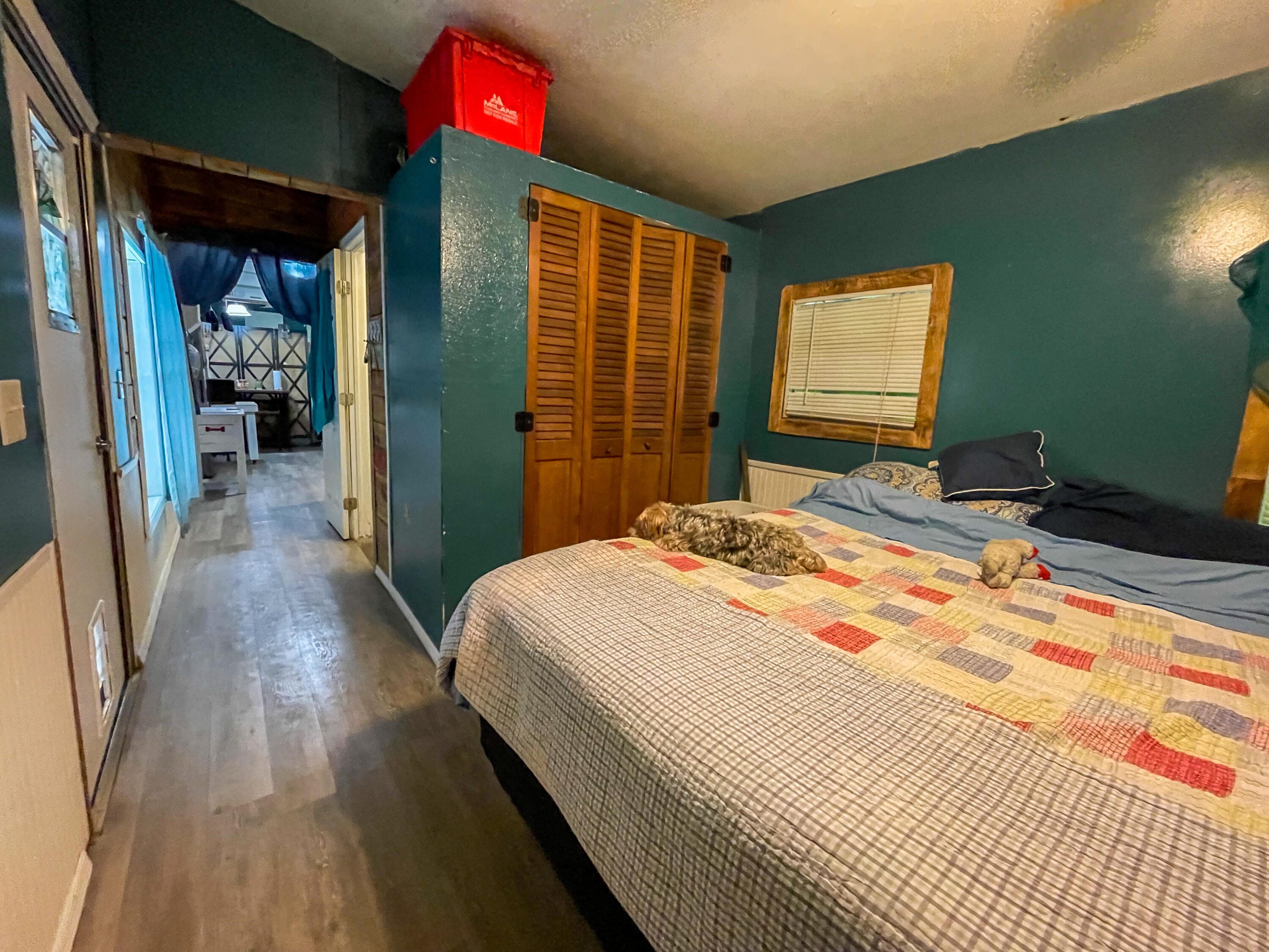 31316 Ave C Big Pine Key, FL 33043 - Photo 24 of 28 a bedroom with a bed and a flat screen tv