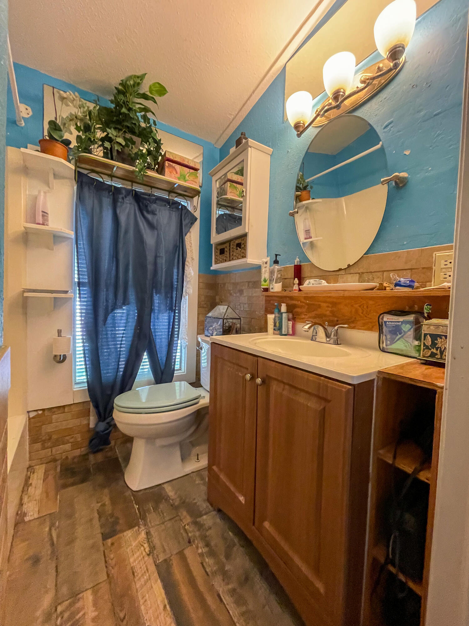 31316 Ave C Big Pine Key, FL 33043 - Photo 25 of 28 a bathroom with a toilet a sink and mirror