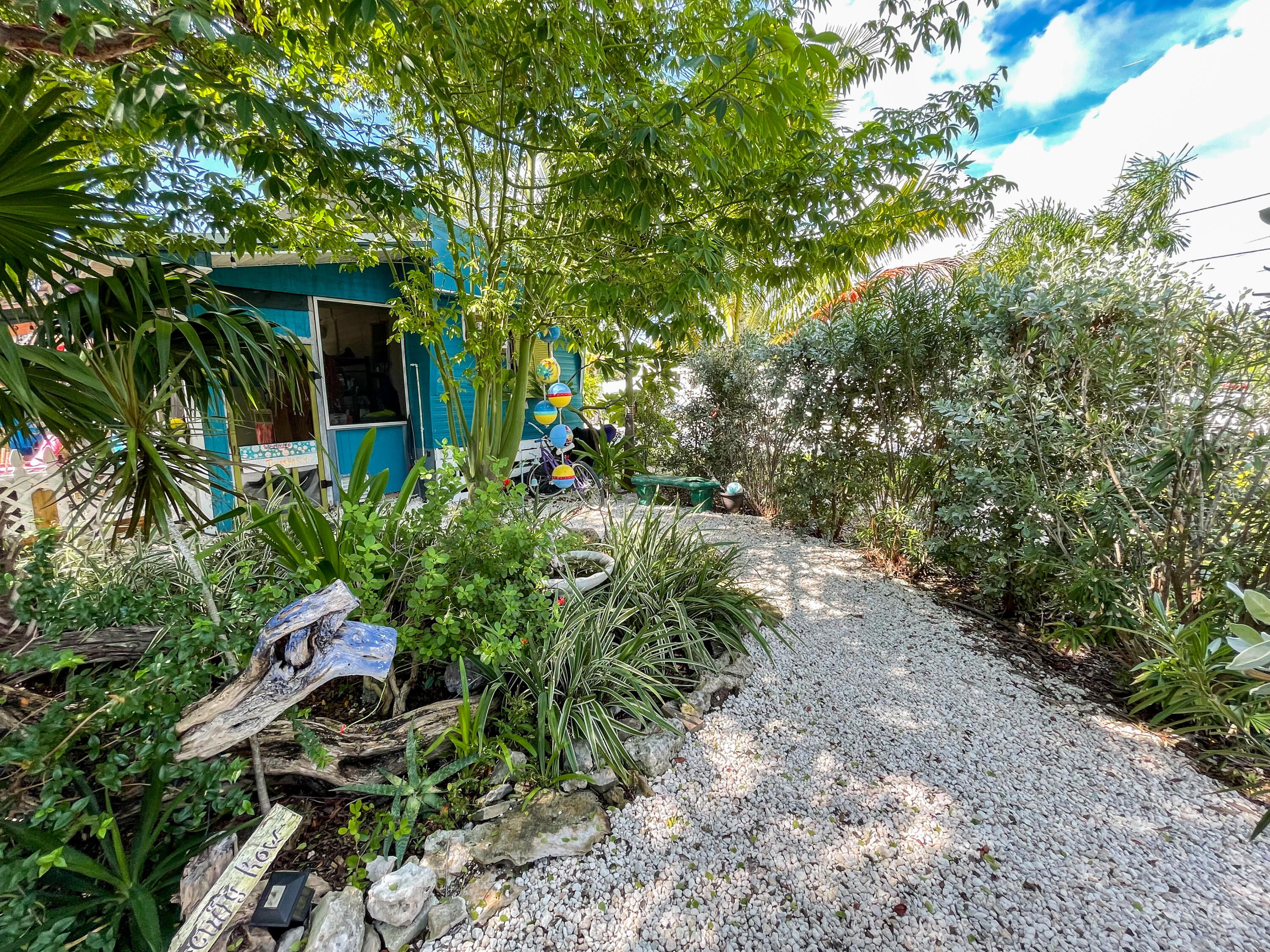 31316 Ave C Big Pine Key, FL 33043 - Photo 9 of 28 a backyard of a house with lots of green space