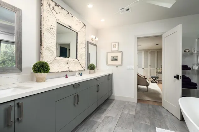 a spacious bathroom with a double vanity sink mirror and toilet