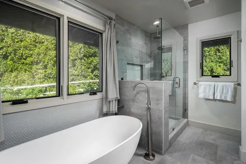 a bathroom with a bathtub and a shower