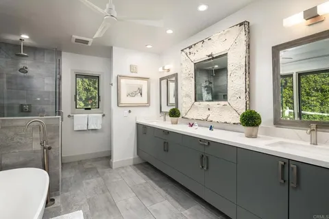 a bathroom with a double vanity sink toilet and shower