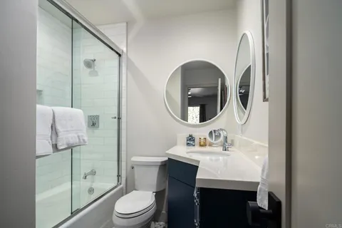 a bathroom with a sink toilet and a mirror