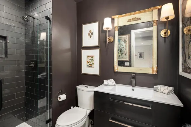 a bathroom with a sink a toilet and shower