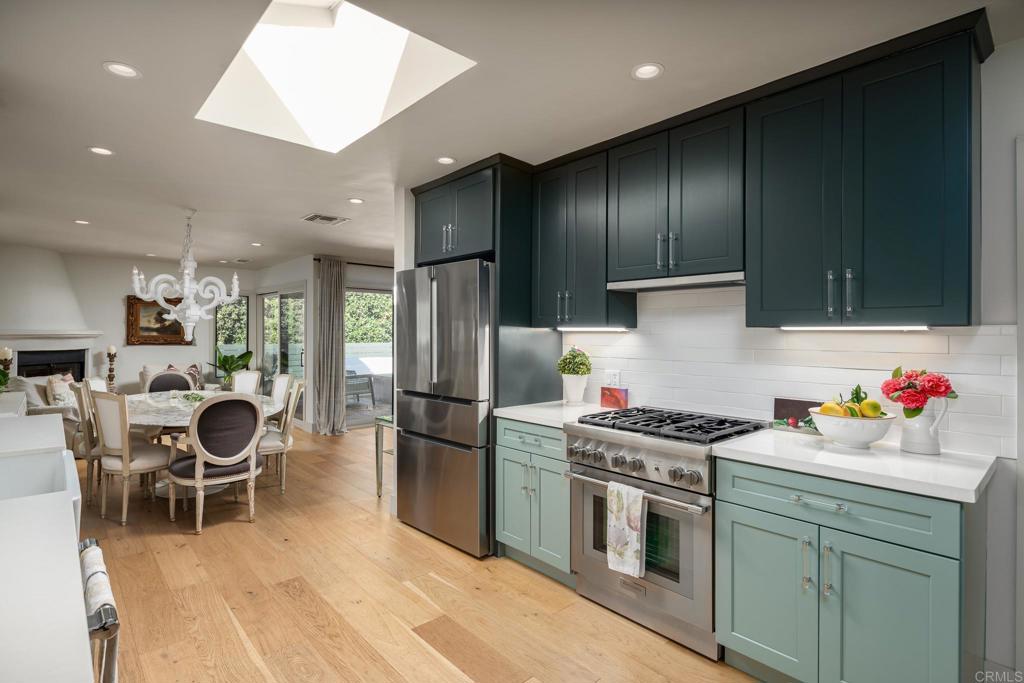 6148 El Tordo Rancho Santa Fe, CA 92067 - Photo 8 of 25 a kitchen with a stove a refrigerator and furniture