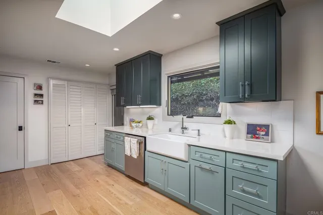 a kitchen with a sink cabinets and window
