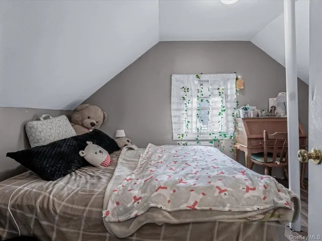 a bedroom with a bed and window