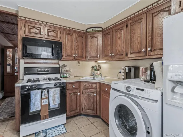 a kitchen with stainless steel appliances granite countertop a stove and a refrigerator