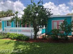 981 8th Terrace North Naples, FL 34102 - Photo 1 of 13 a view of a house with a small yard and flower garden