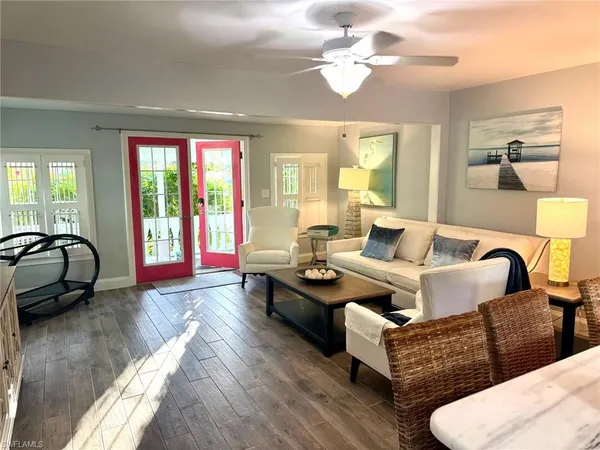 a living room with furniture ceiling fan and a rug