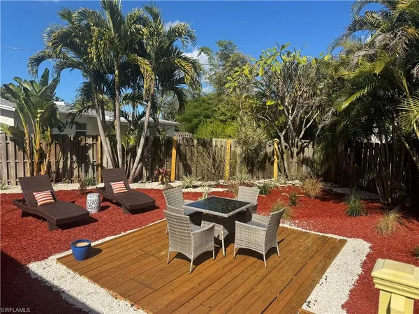 a view of a backyard with sitting area