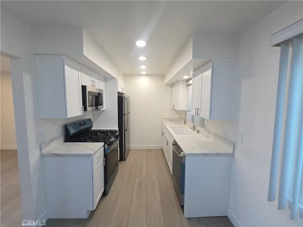 a kitchen with a sink stove and cabinets
