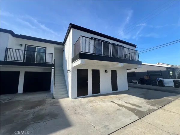 a view of a house with a barbeque and stairs