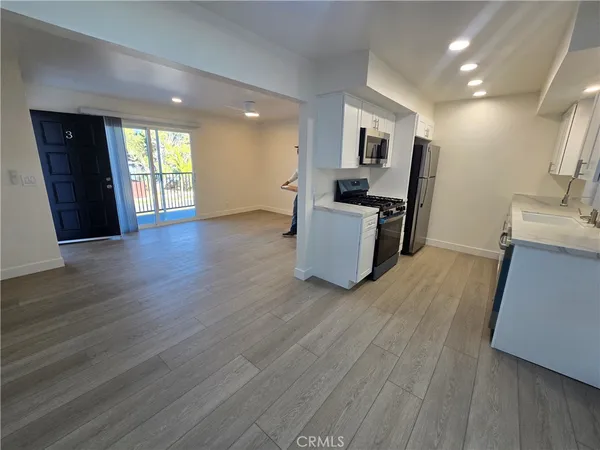 a view of kitchen with cabinets and wooden floor