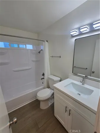 a bathroom with a sink toilet a mirror and shower