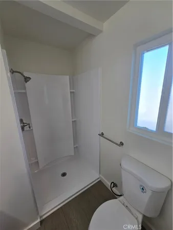 a bathroom with a toilet and shower