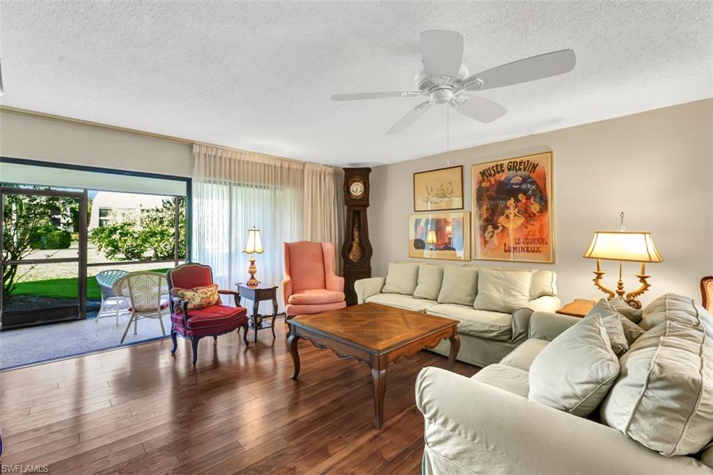 1617 Spoonbill Lane, Unit 1617 Naples, FL 34105 - Photo 1 of 31 a living room with furniture and a large window