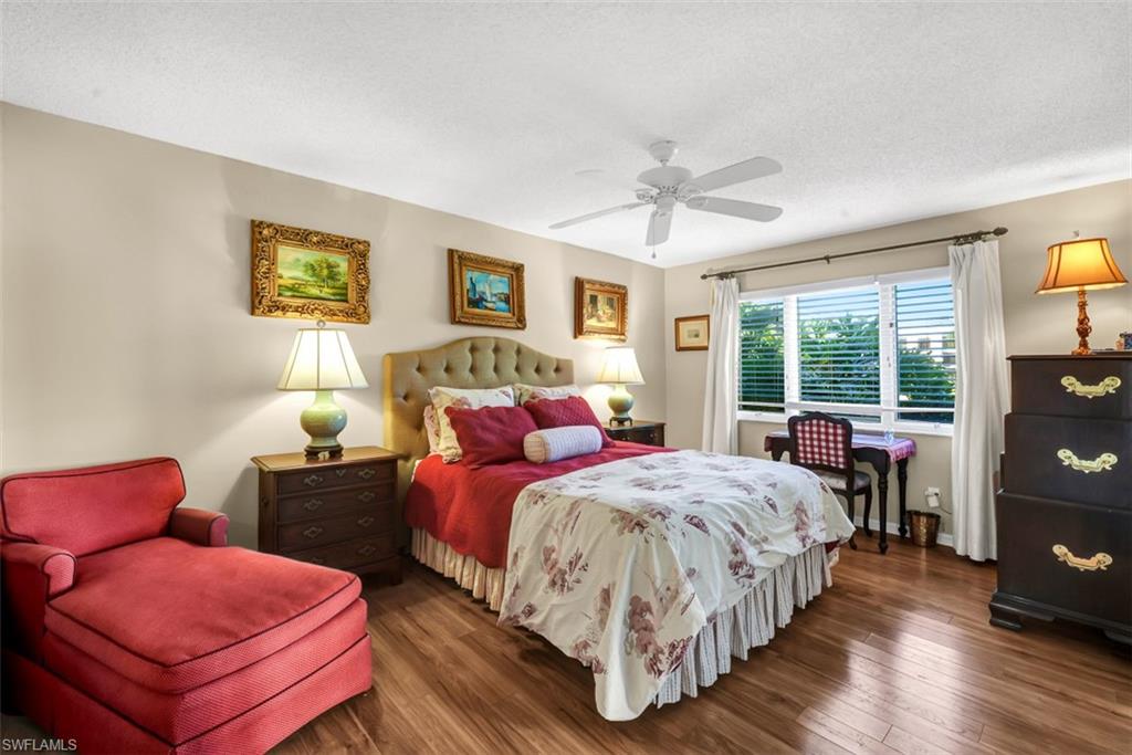 1617 Spoonbill Lane, Unit 1617 Naples, FL 34105 - Photo 11 of 31 a bedroom with two beds and a large window