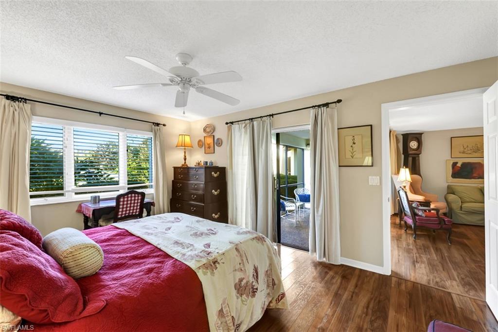 1617 Spoonbill Lane, Unit 1617 Naples, FL 34105 - Photo 12 of 31 a bedroom with a large bed and a large window