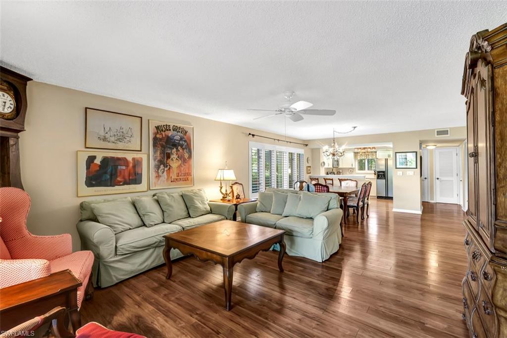 1617 Spoonbill Lane, Unit 1617 Naples, FL 34105 - Photo 2 of 31 a living room with furniture and a table