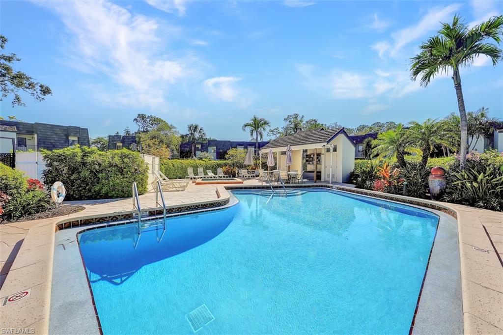 1617 Spoonbill Lane, Unit 1617 Naples, FL 34105 - Photo 22 of 31 a view of a swimming pool with a patio