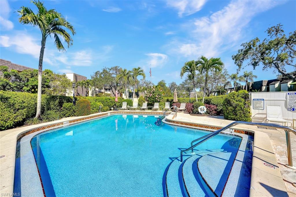 1617 Spoonbill Lane, Unit 1617 Naples, FL 34105 - Photo 24 of 31 a view of a swimming pool and lounge chair