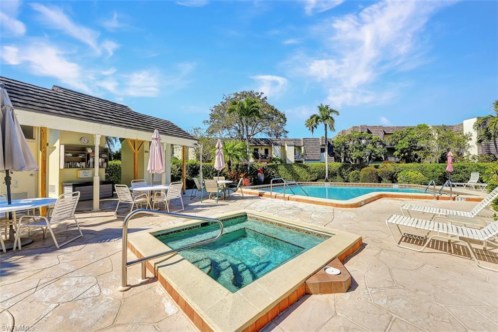 1617 Spoonbill Lane, Unit 1617 Naples, FL 34105 - Photo 25 of 31 a view of a house with swimming pool and sitting area