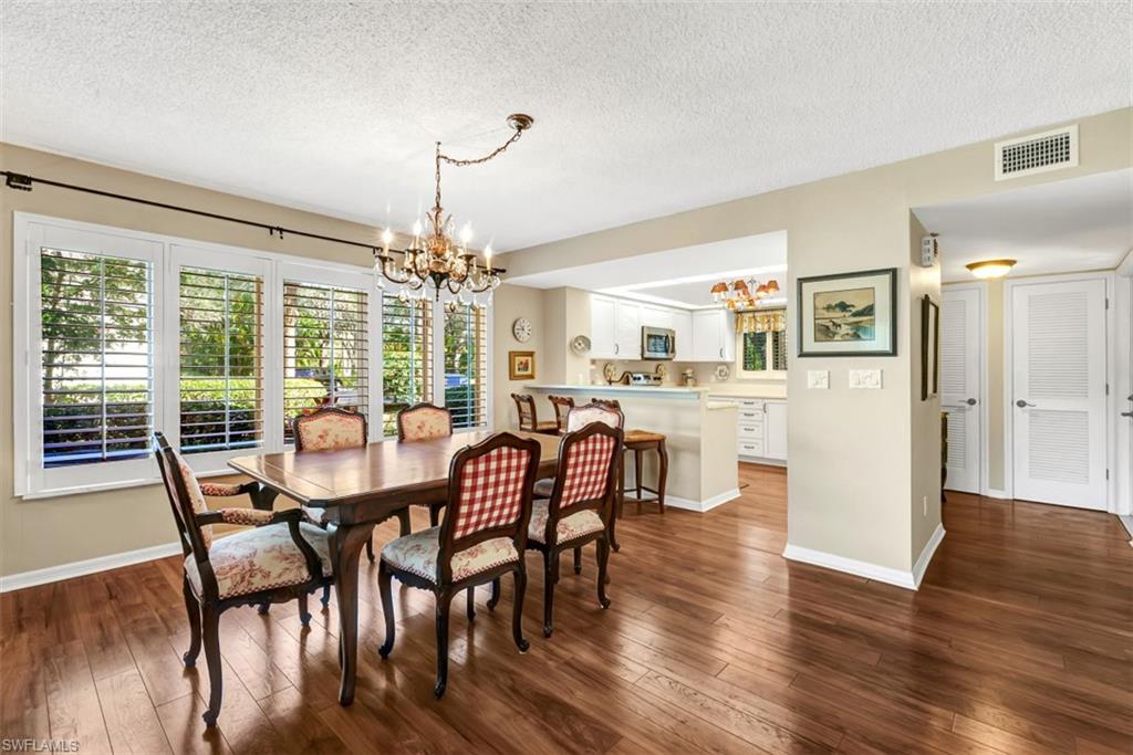 1617 Spoonbill Lane, Unit 1617 Naples, FL 34105 - Photo 8 of 31 a dining room with furniture window and wooden floor